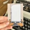 Beige adressticker met okergele typemachine en wit papier met typemachine op achtergrond